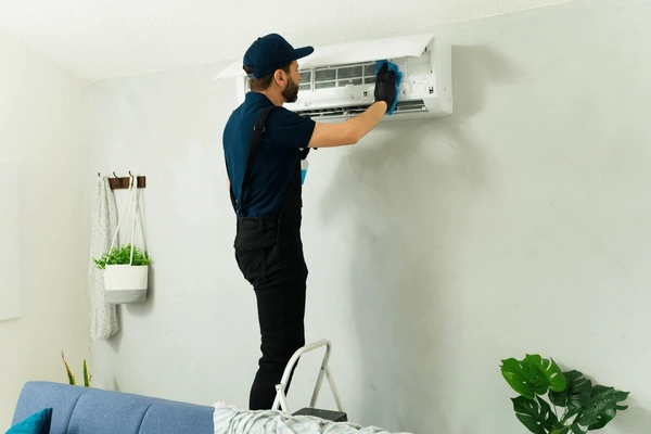 HVAC technician installing energy-efficient air conditioner in Skiatook OK