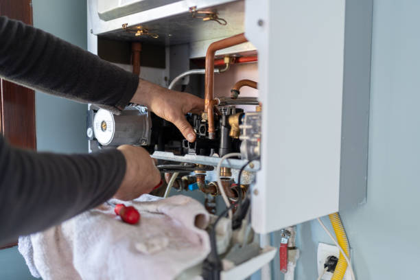Technician completing furnace installation checks in a Glenpool, OK utility room while testing airflow